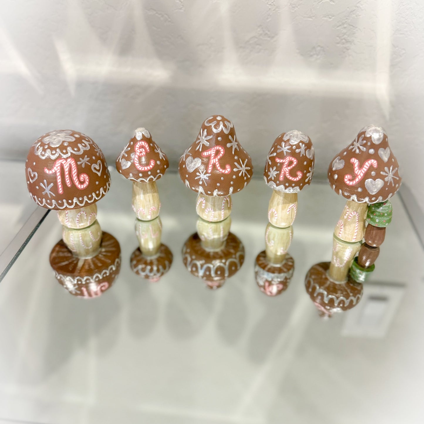 Decorative mushroom-shaped items with decorative elements on a white surface