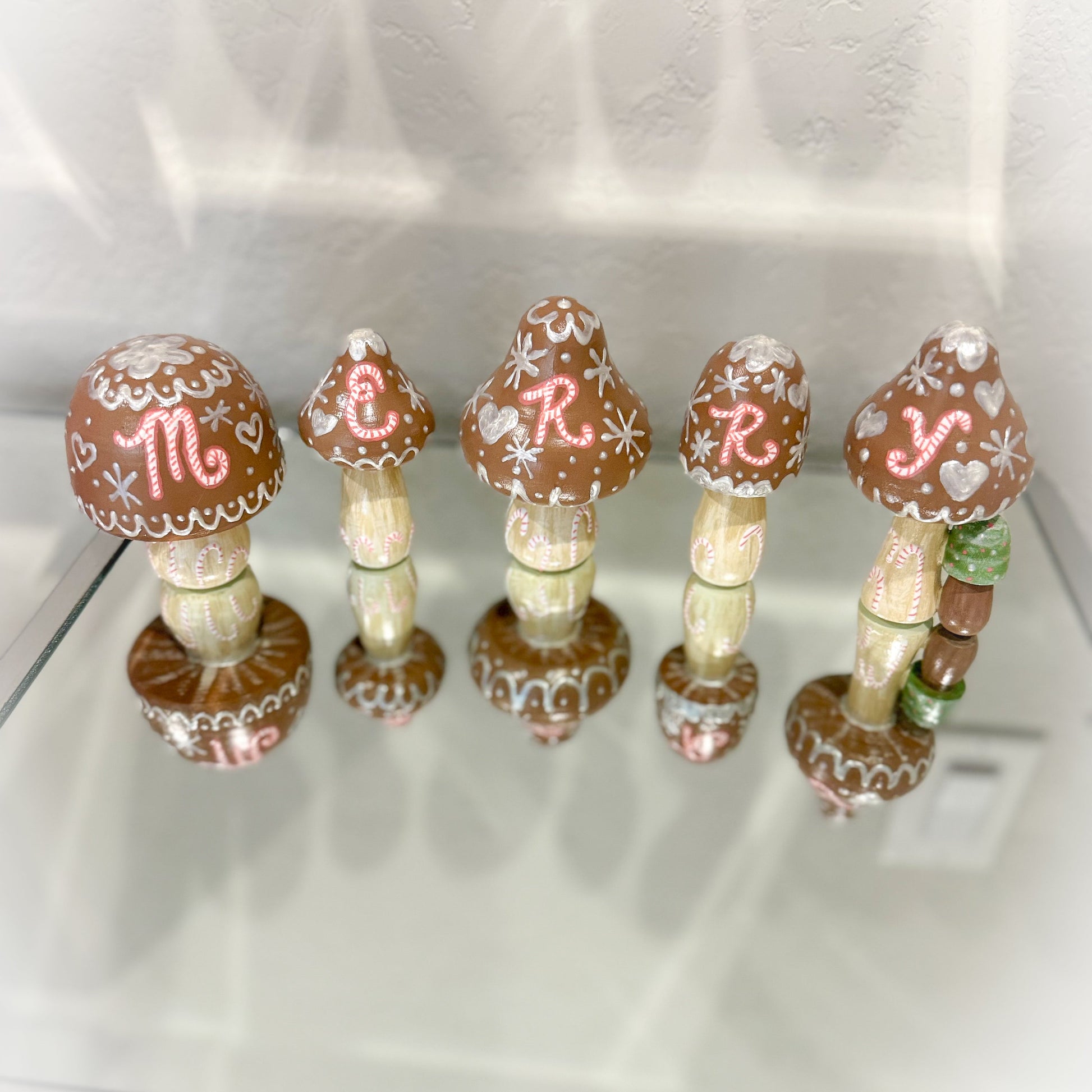 Decorative mushroom-shaped items with decorative elements on a white surface