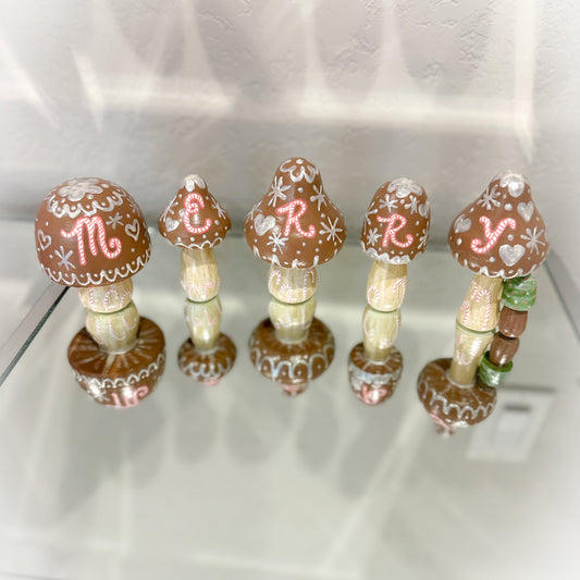 Decorative mushroom-shaped items with decorative elements on a white surface
